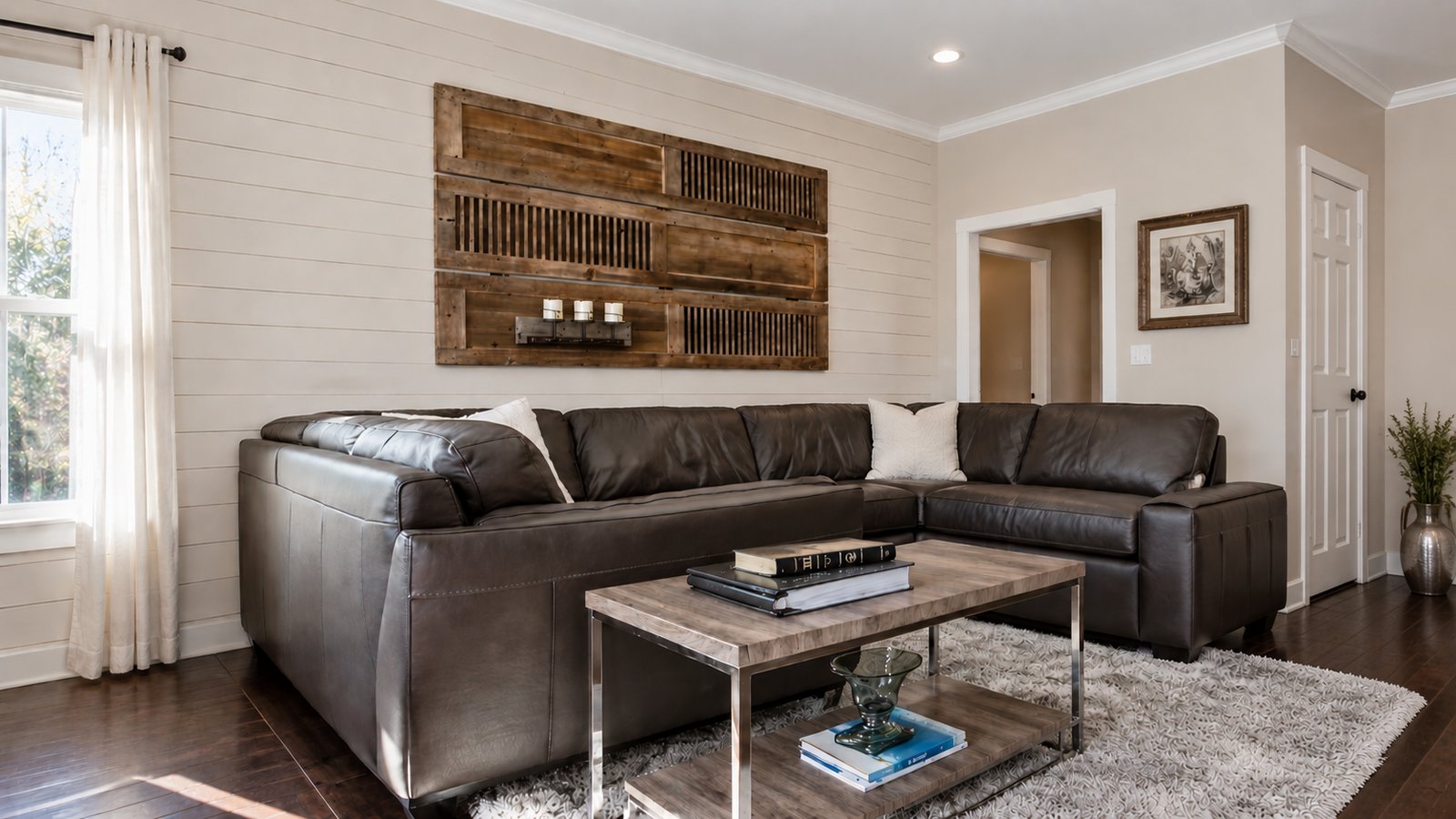 Cozy den with shiplap wall, leather sectional, and rustic wood art panel