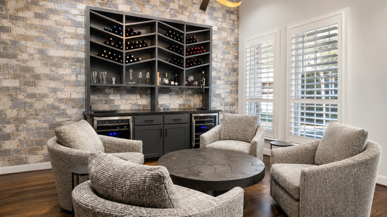 Lounge seating with wine storage built into the wall beside a stone surface