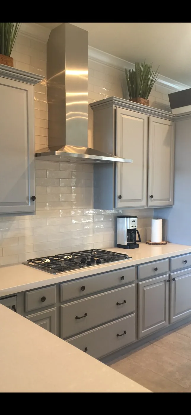 Kitchen with gray cabinets and a clean backsplash