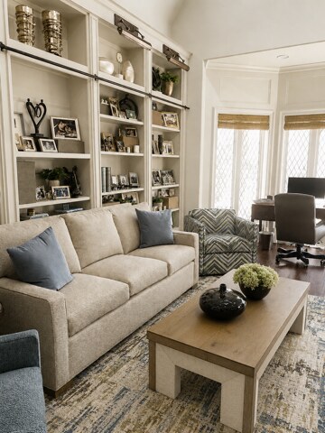 Lakehouse living room with custom built-ins, neutral seating, blue accents, and an adjoining home office